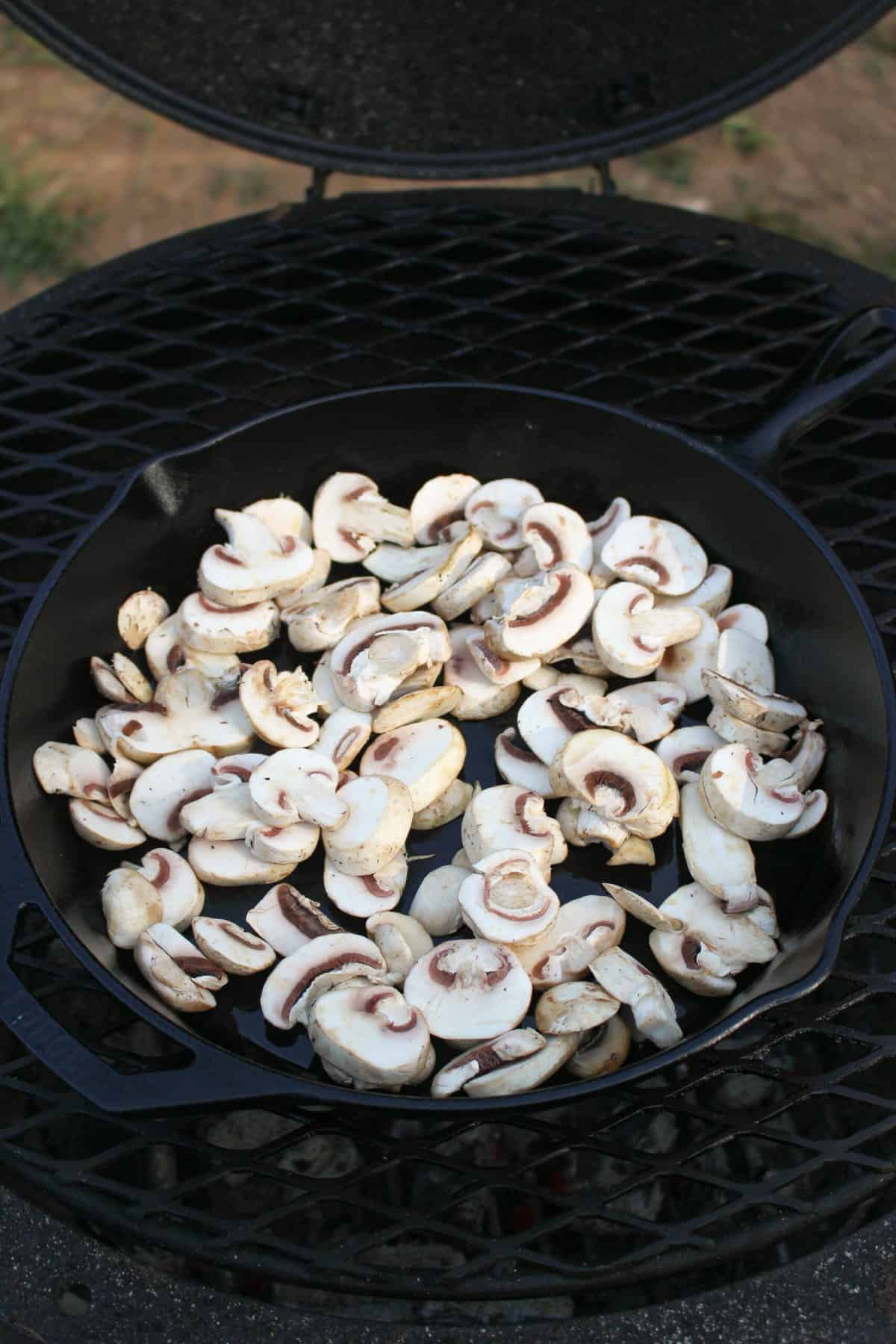 overhead of sliced white mushrooms in a skillet