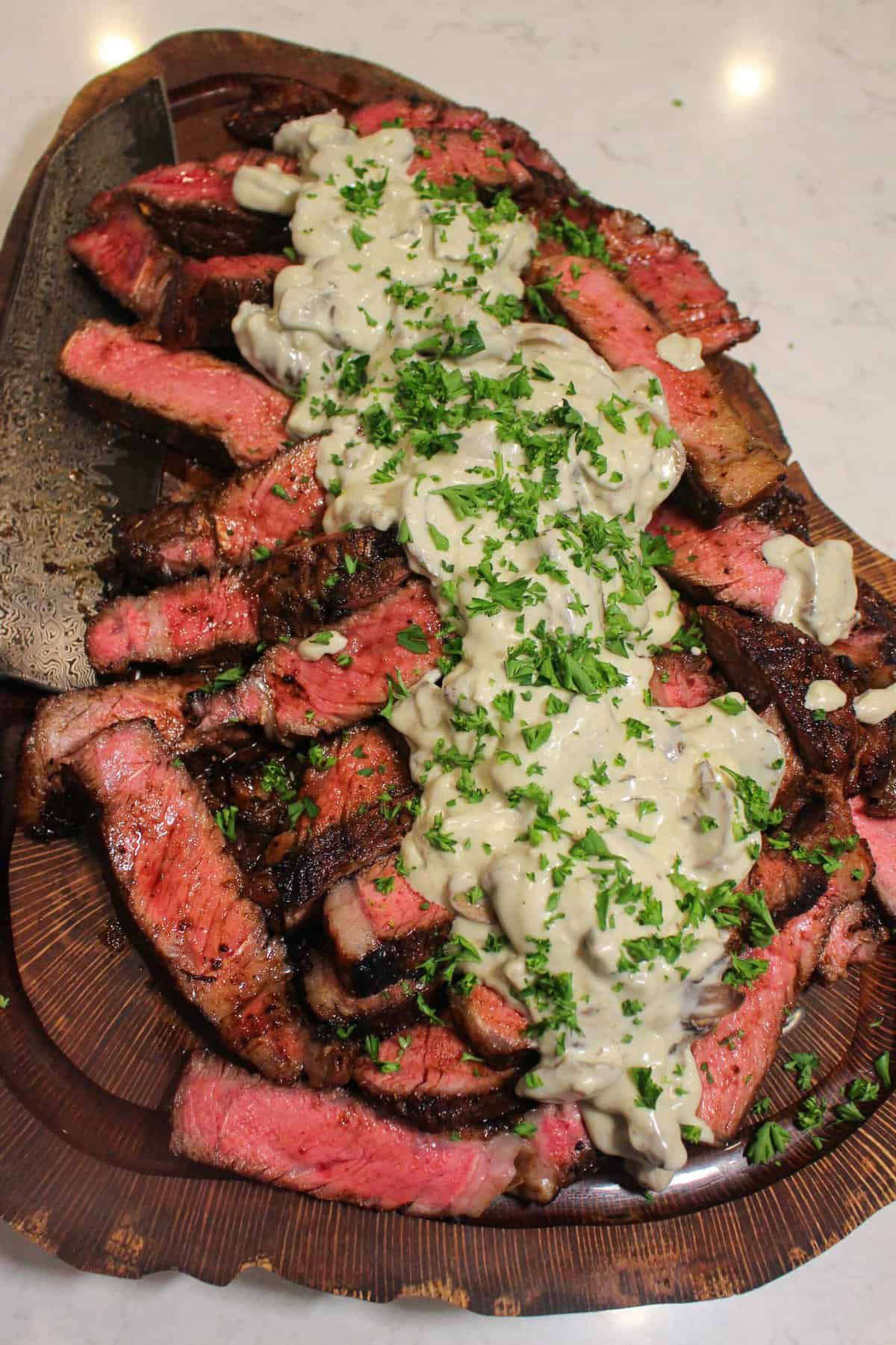 finished bourbon marinated ribeyes topped with cream sauce from above