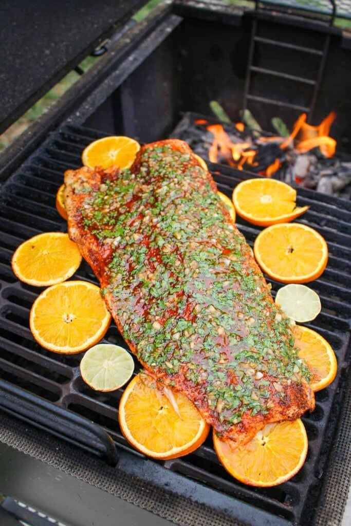 planked salmon on the grill topped with chili lime sauce overhead