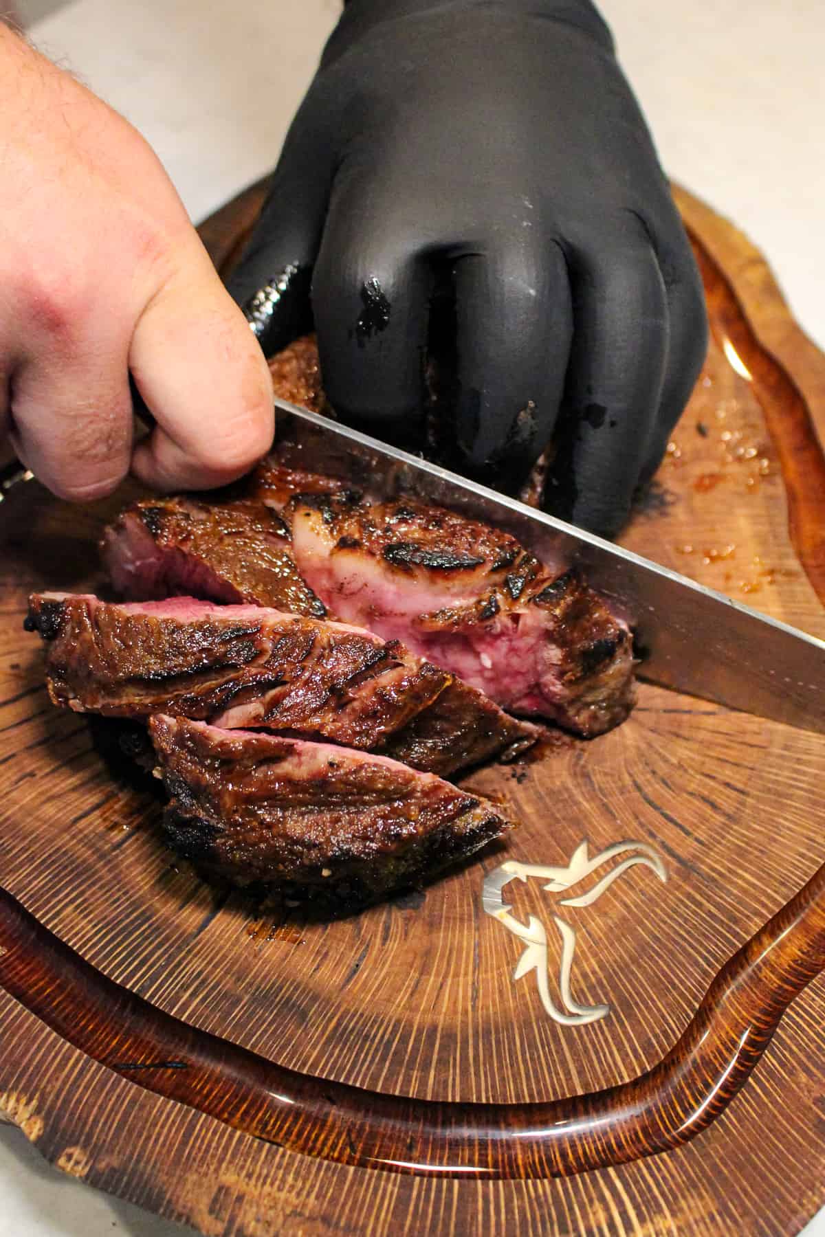 steak being sliced on a cutting board overhead