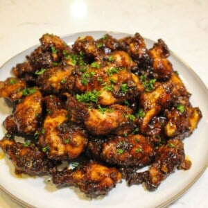 overhead of a plate of honey chipotle garlic chicken wings