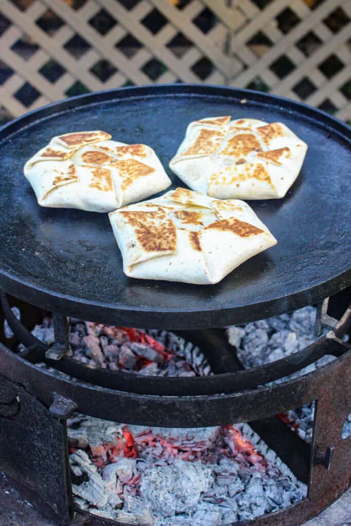 Carne Asada Crunch Wraps getting toasted on the grill.