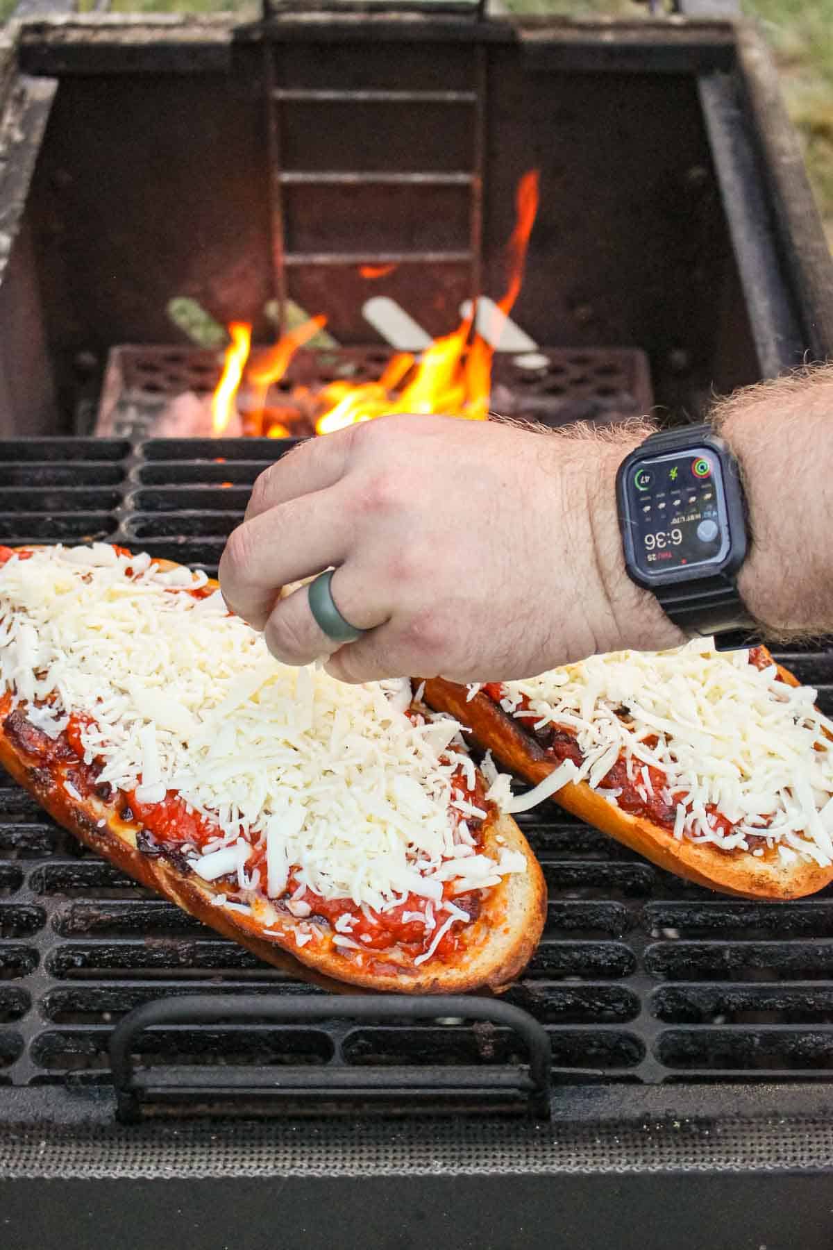 mozzarella cheese being added onto pizza bread
