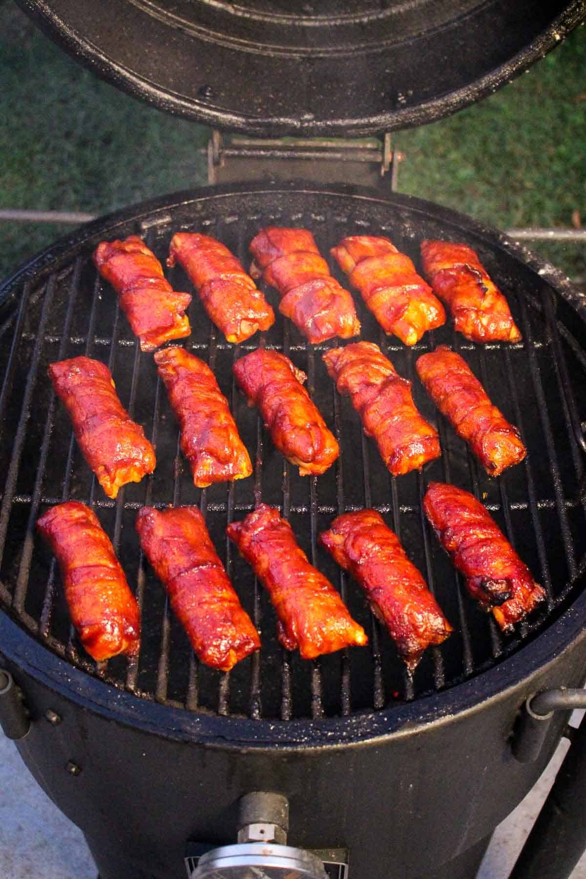 smoked shotgun shells lined on a grill grate
