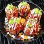 finished BBQ volcano potatoes topped with garnishes overhead