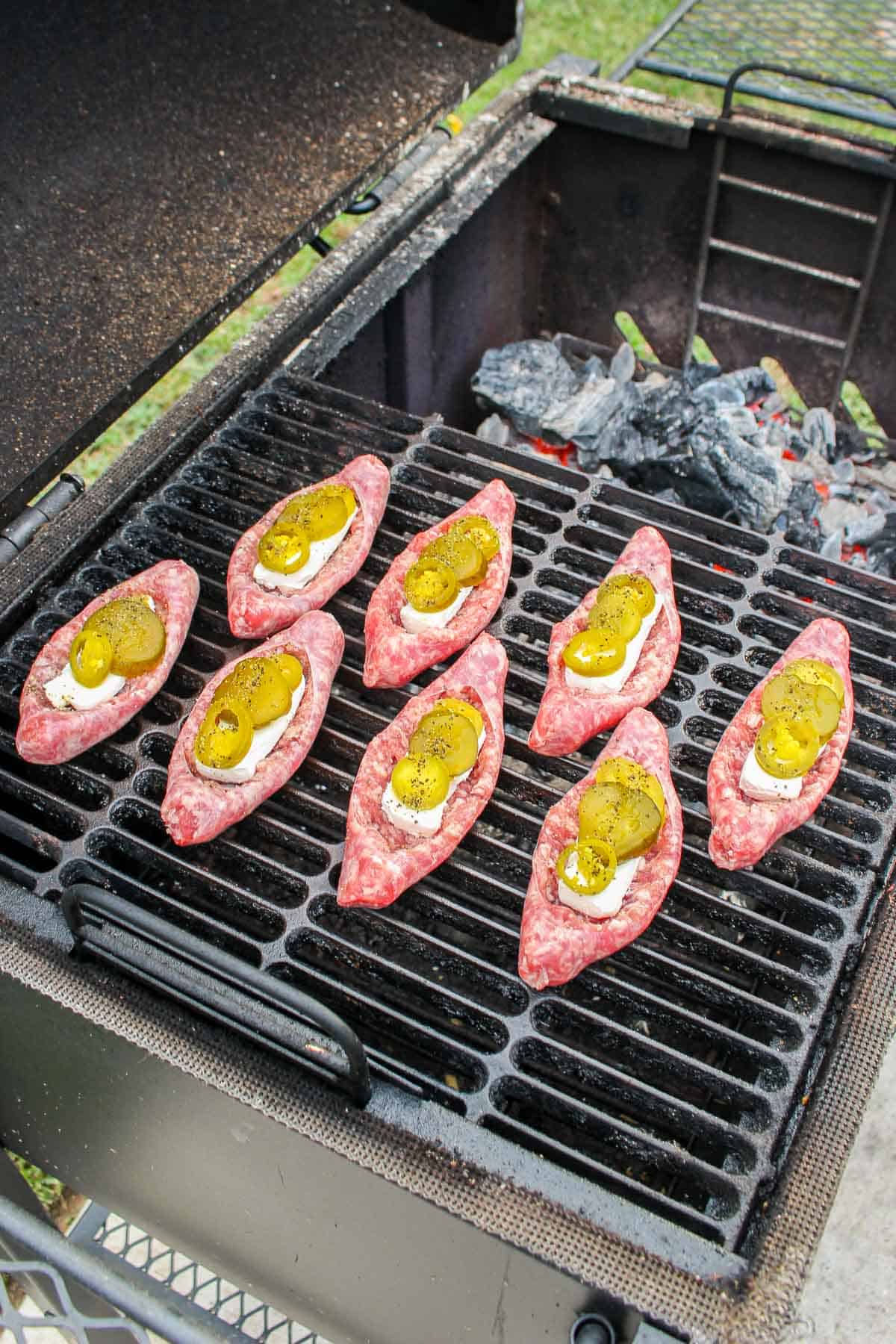 overhead of sausage poppers on a grill