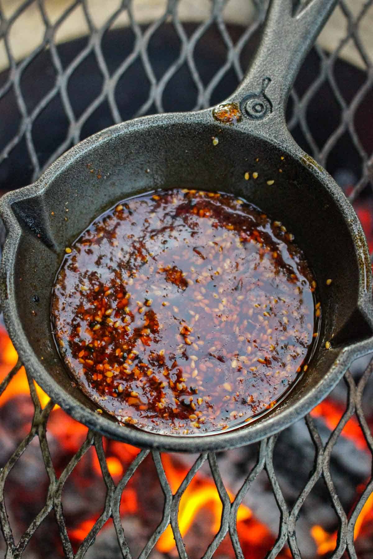 chili oil glaze in a skillet on a smoker