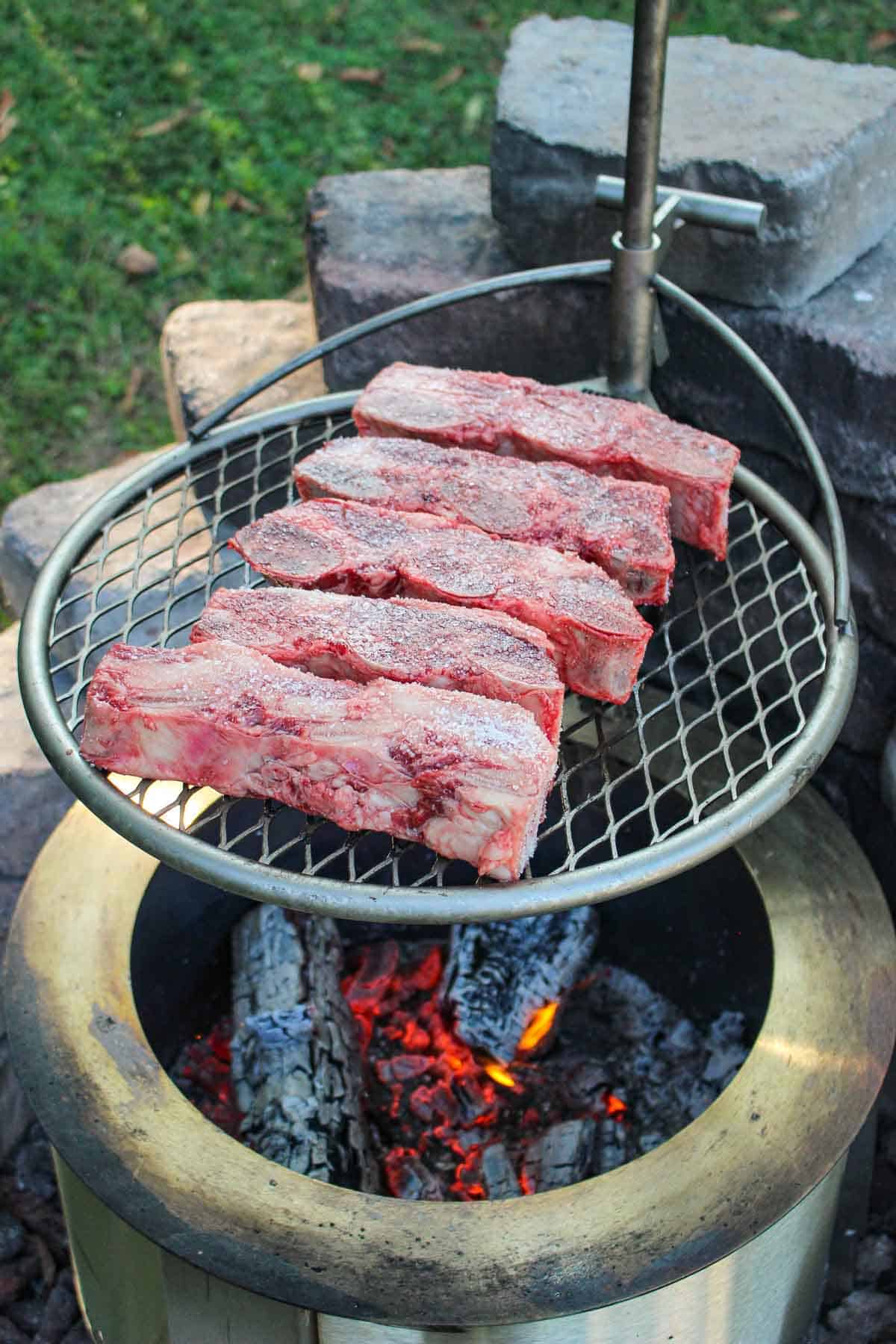 Uncooked flanken short ribs getting ready to be cooked over the Breeo smokeless firepit. 