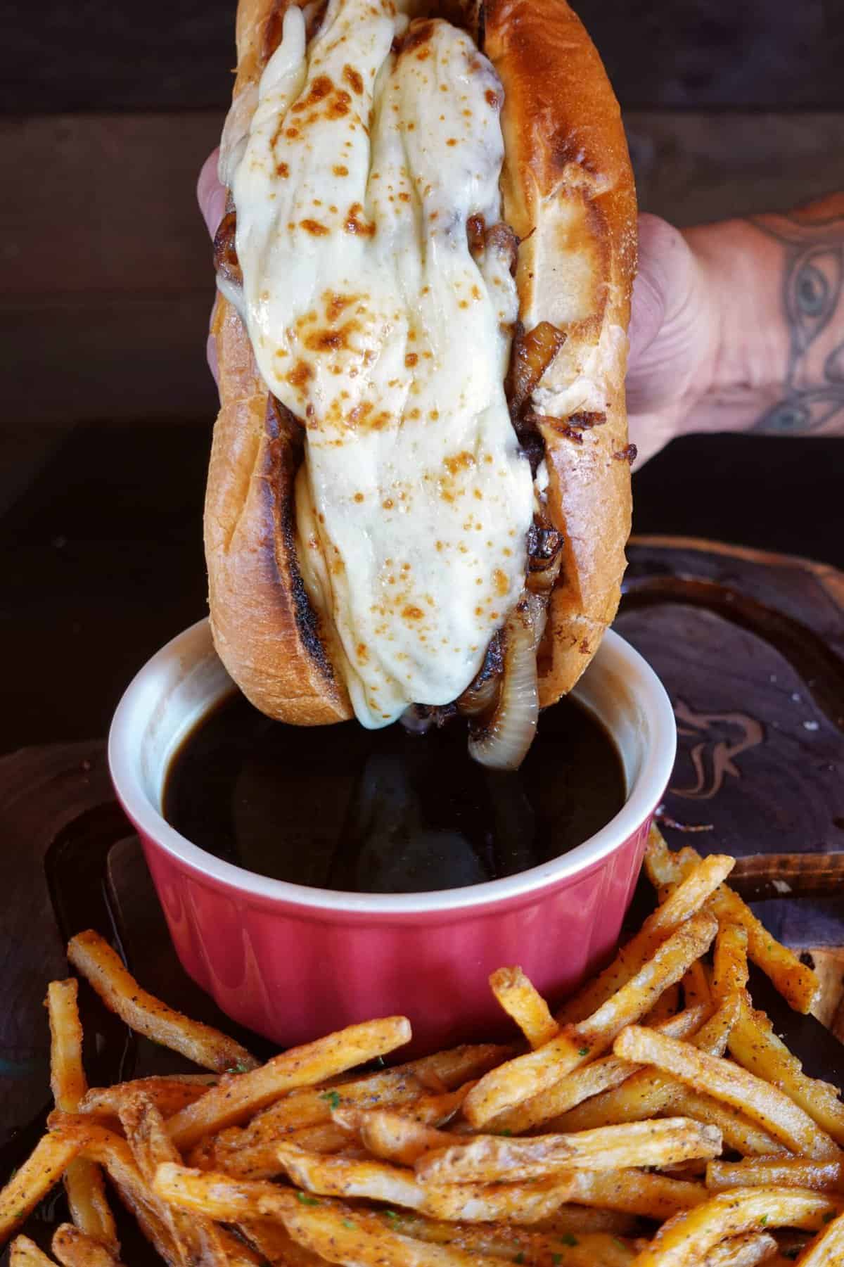 Sandwich about to get dunked in the au jus.