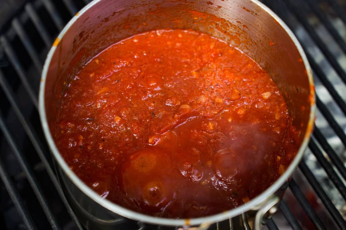 The red sauce for the Spicy Meatball Sub boiling on the grill.