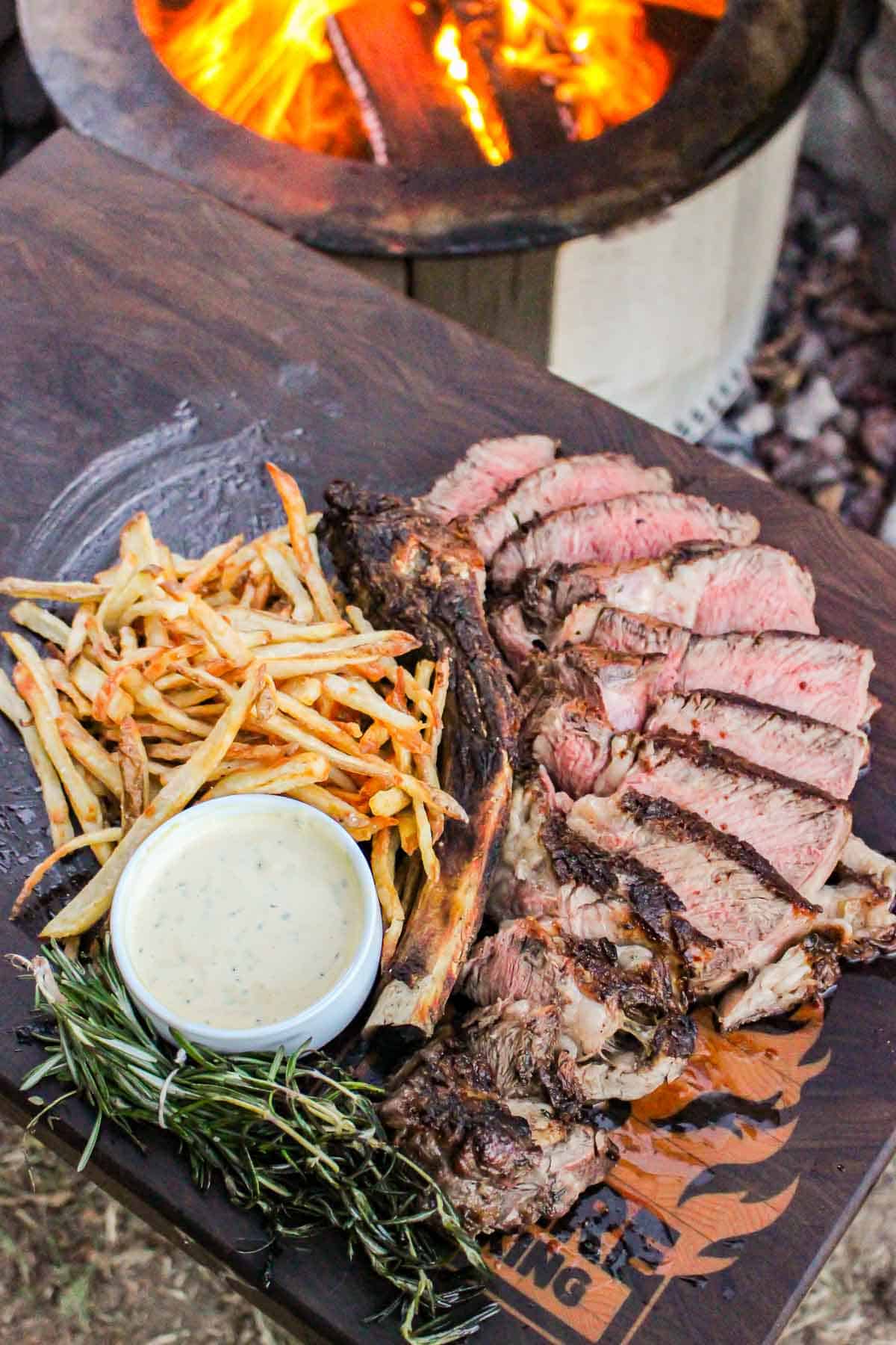 Grilled ribeye and beef tallow fries sliced and served.