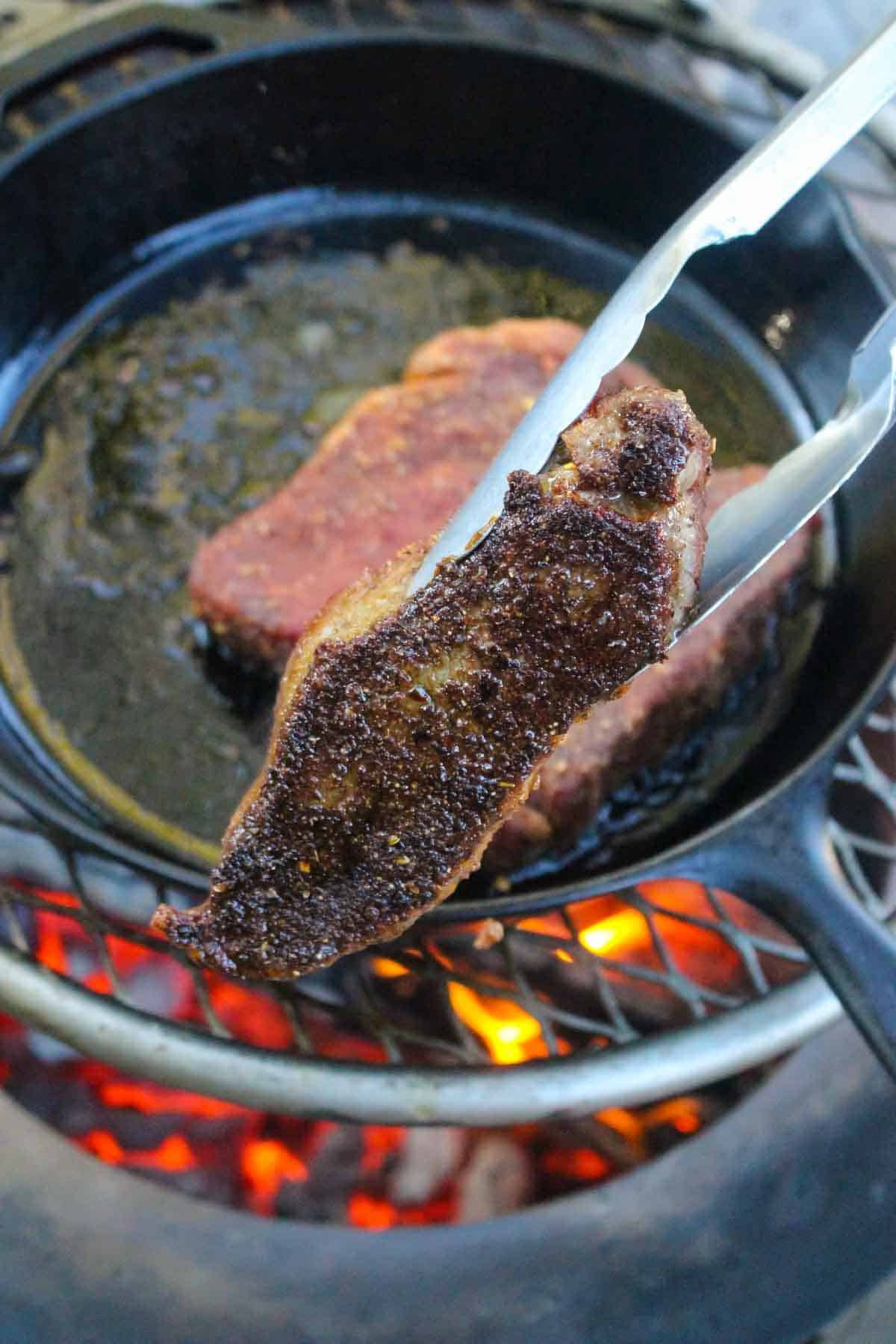 The flip and sear of the NY steaks.