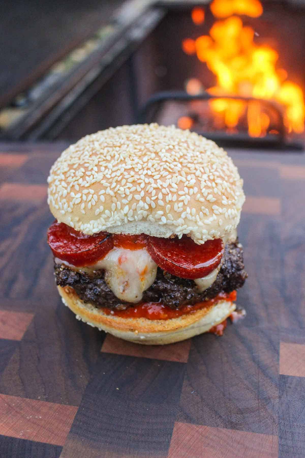 A close up photo of one Smoked Pizza Burger.