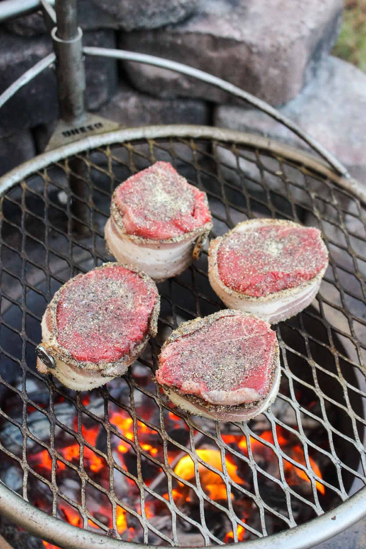 Placing the seasoned filets on the grill.