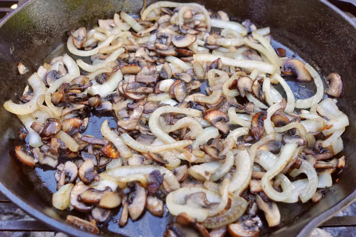 The mushrooms and onions as they finish cooking on the grill. 