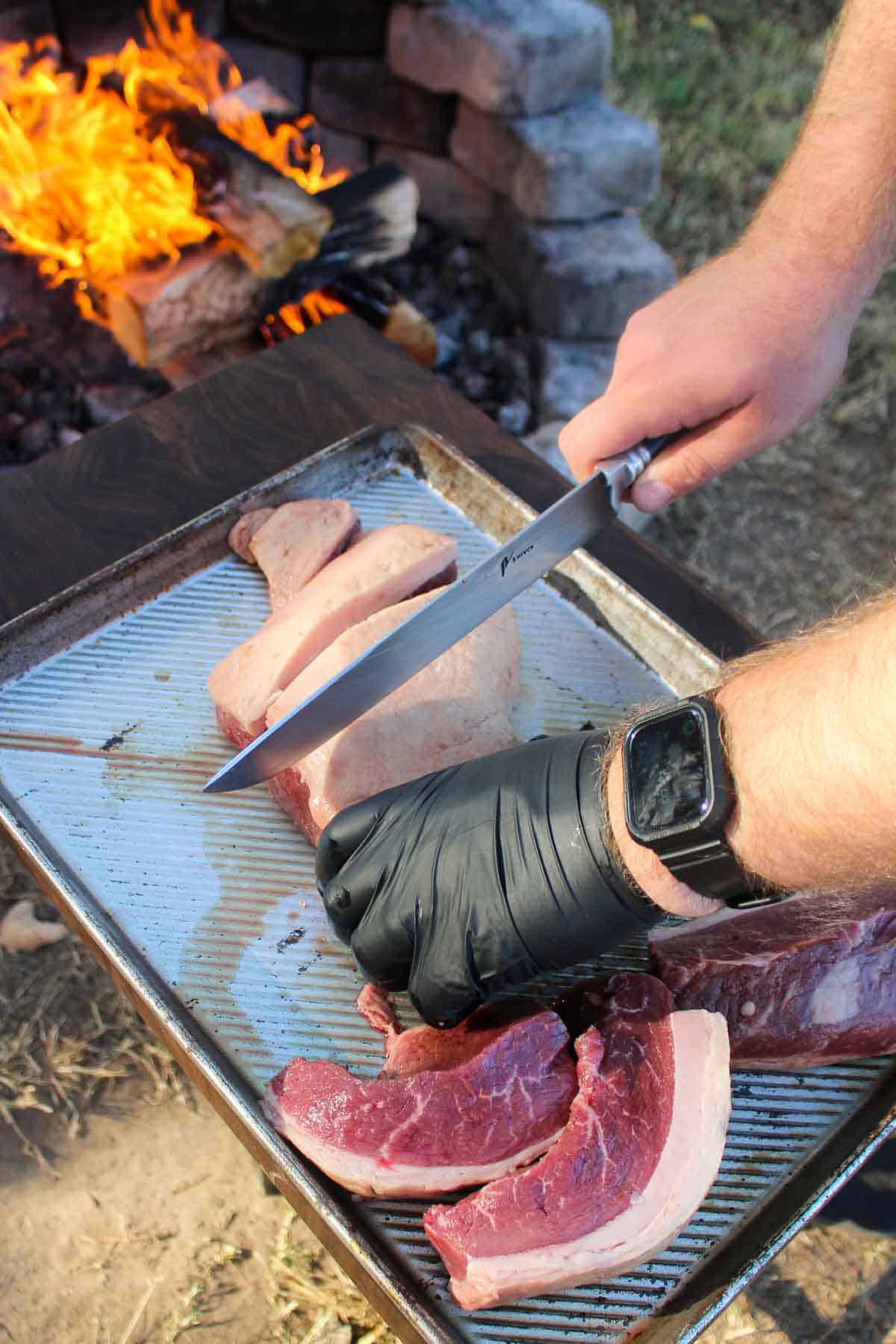 Slicing the picanha on a cutting board.