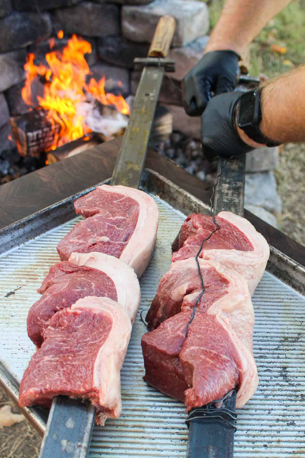 Skewered piranha getting secured before cooking.