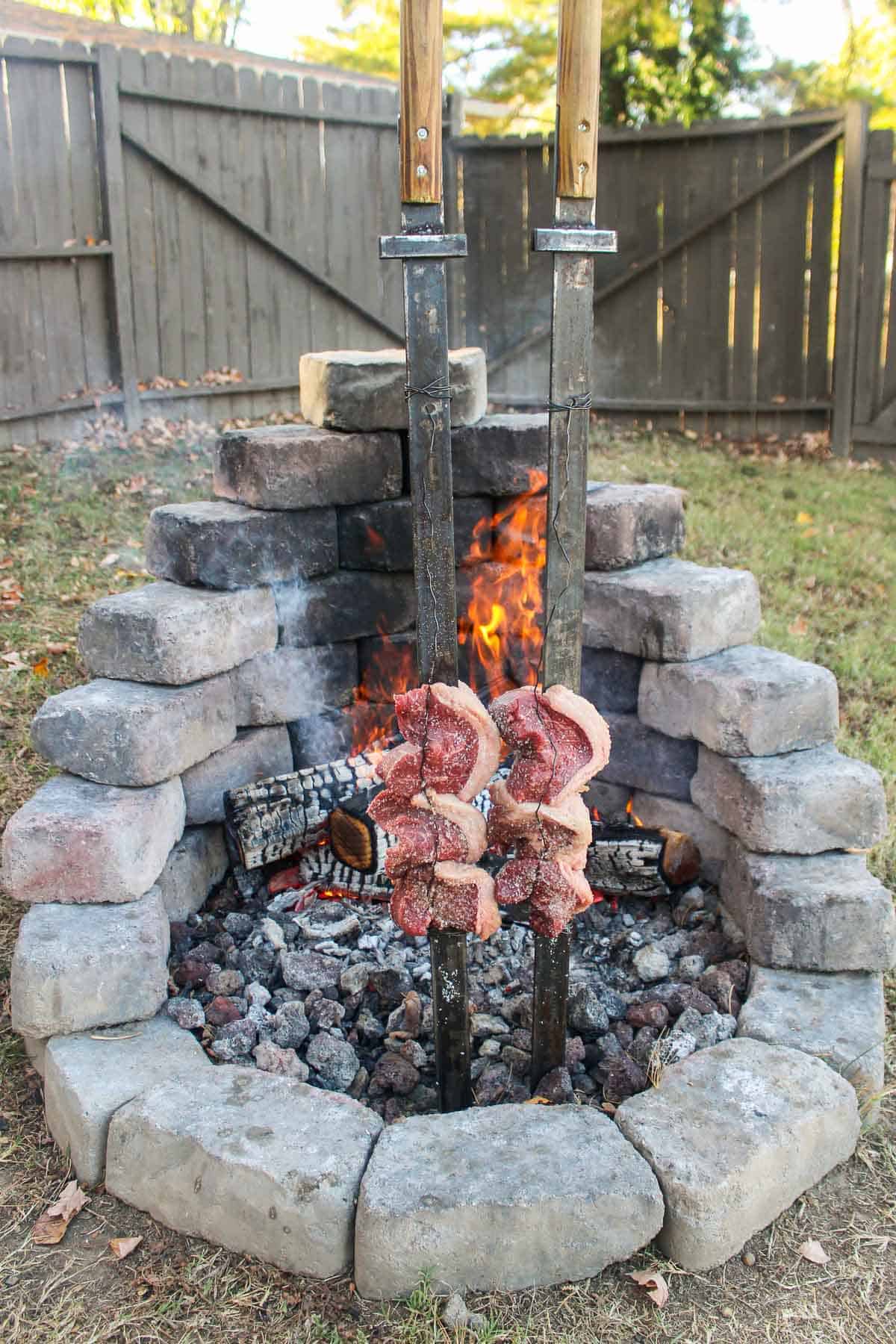 The skewered picanha sitting next to the flames.