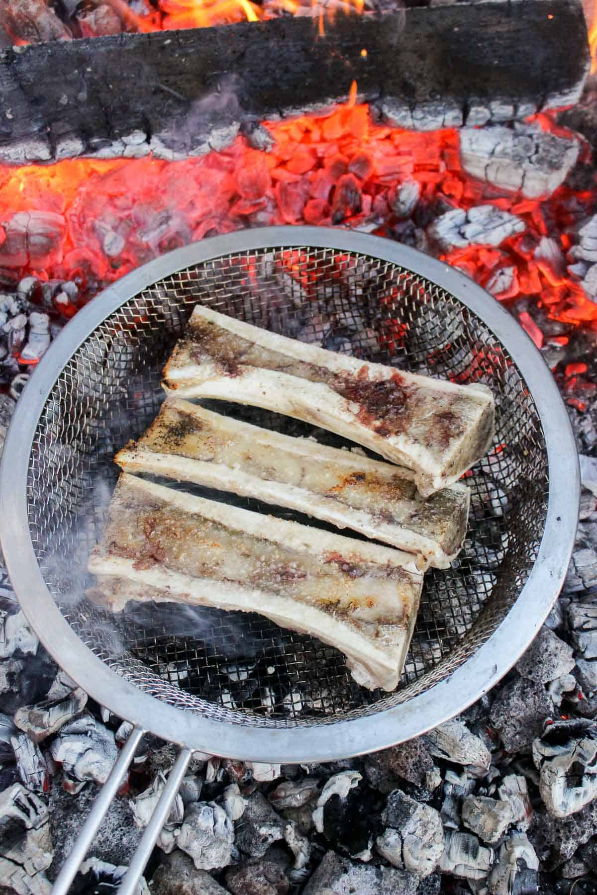 Bone Marrow cooking over the coals in preparation for the Chimichurri.