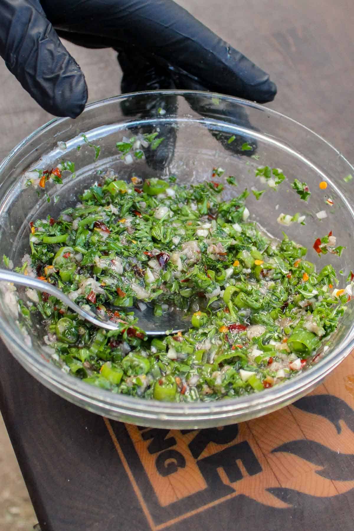 Mixing the bone marrow Chimichurri together in a bowl