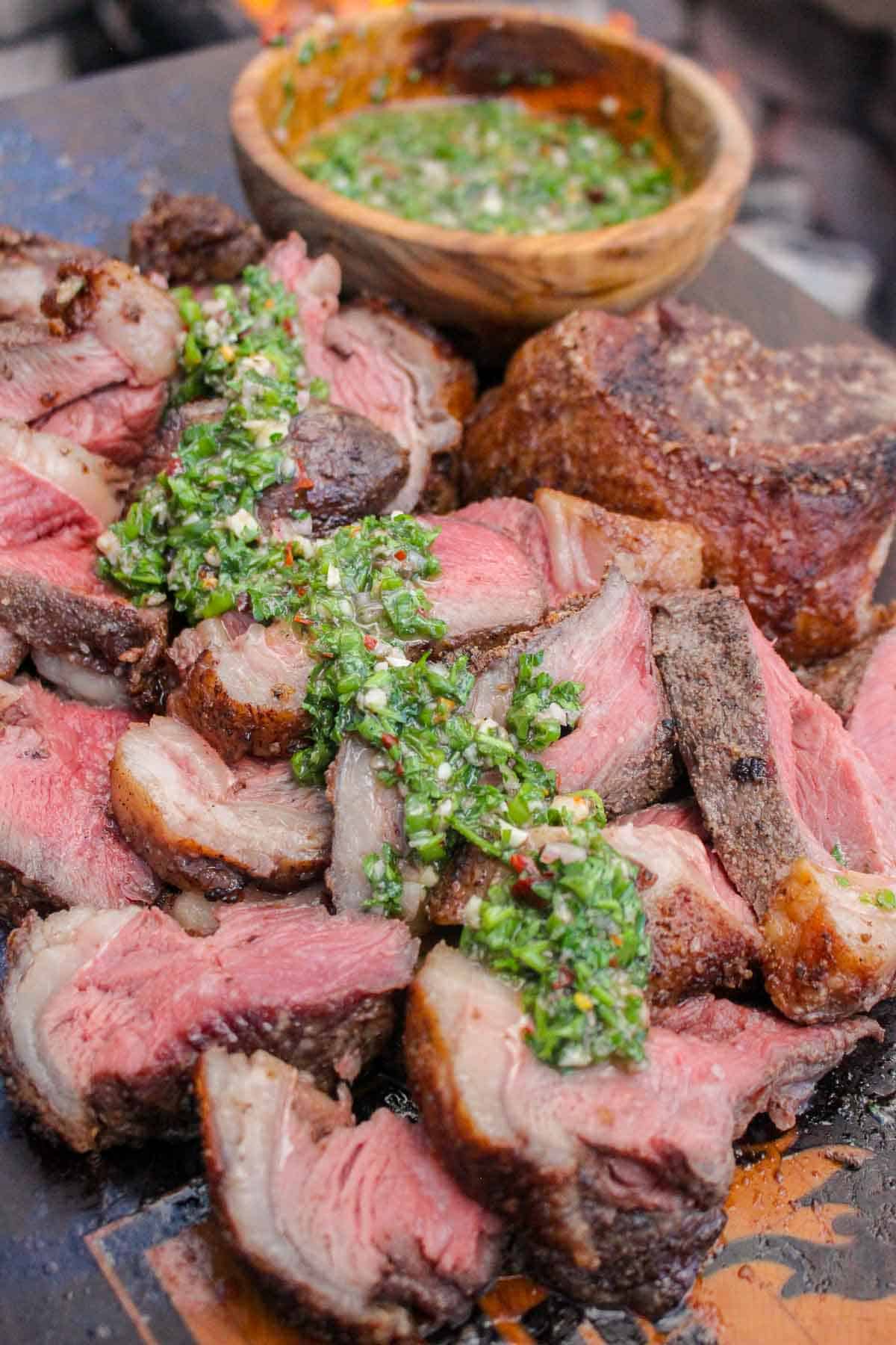 A close up shot of the skewered picanha with bone marrow Chimichurri.