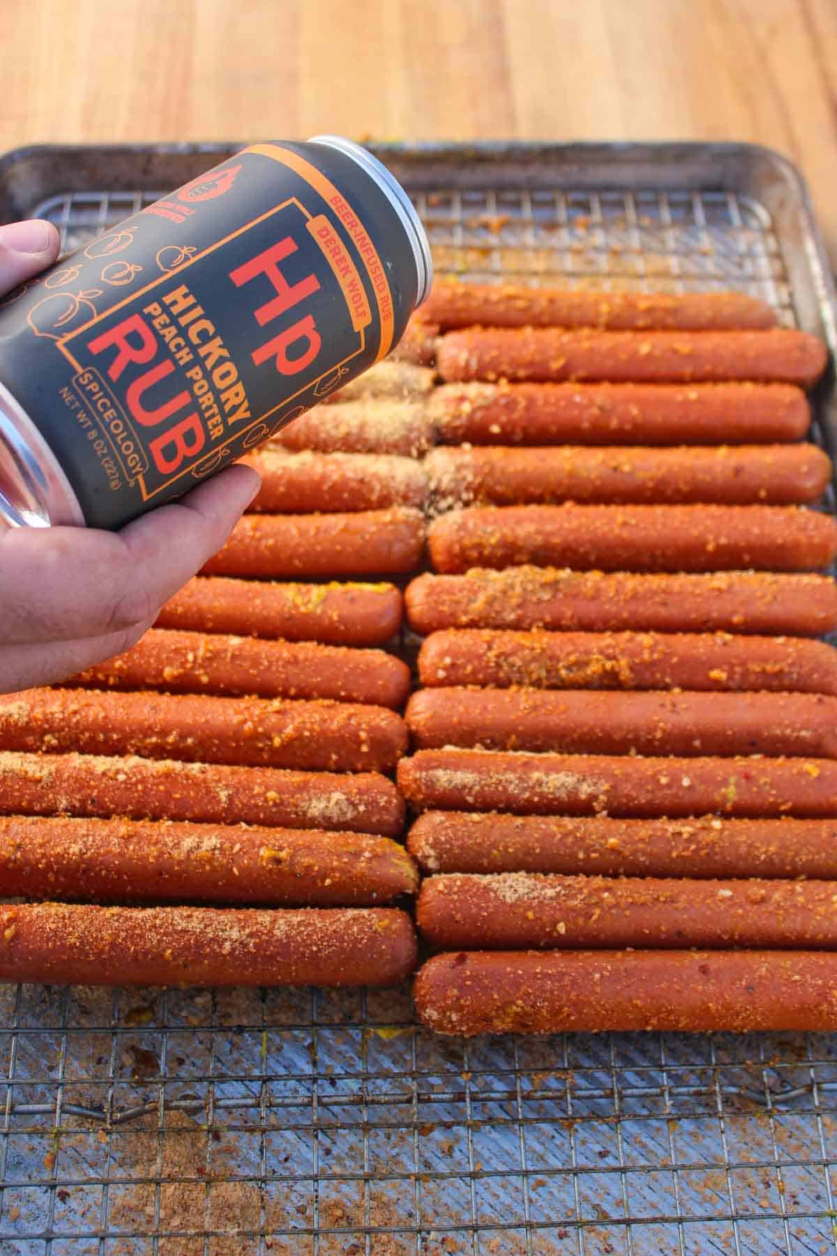 Lathering the hot dogs down with Derek's Hickory Peach Porter Rub.