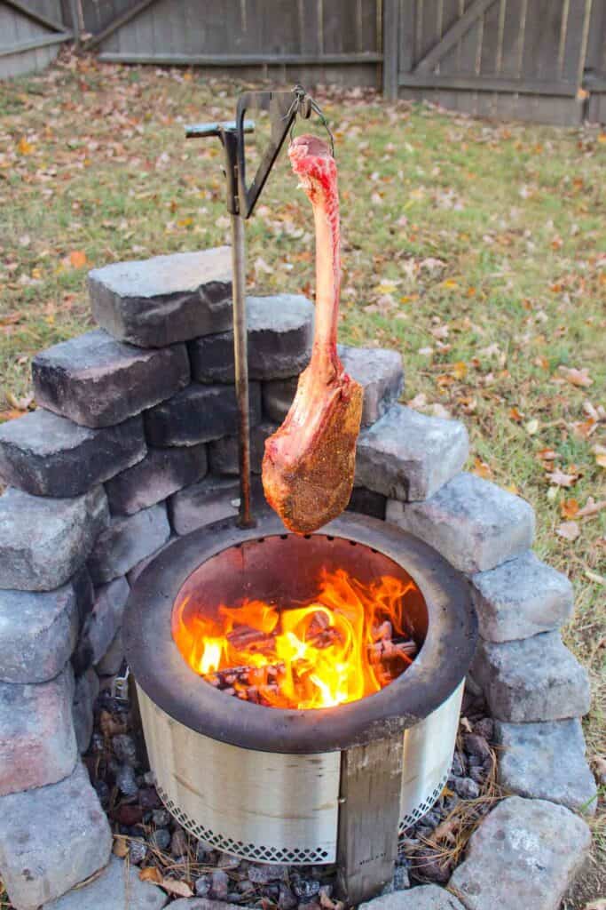 Hanging Tomahawk Steak over the flames.