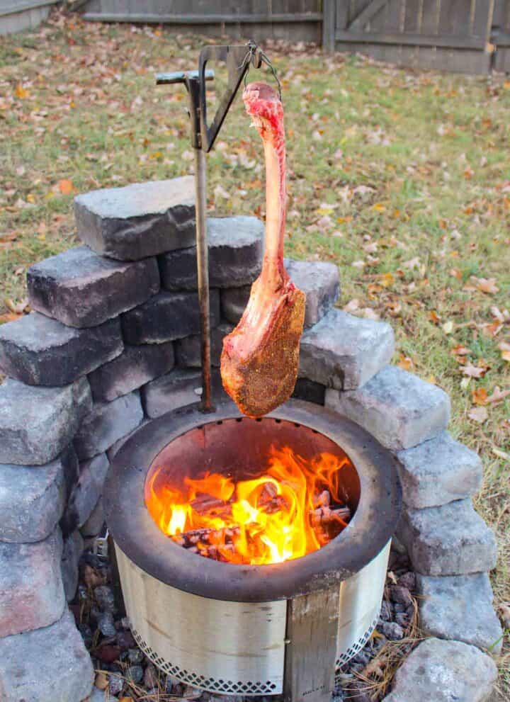 Hanging Tomahawk Steak over the flames.