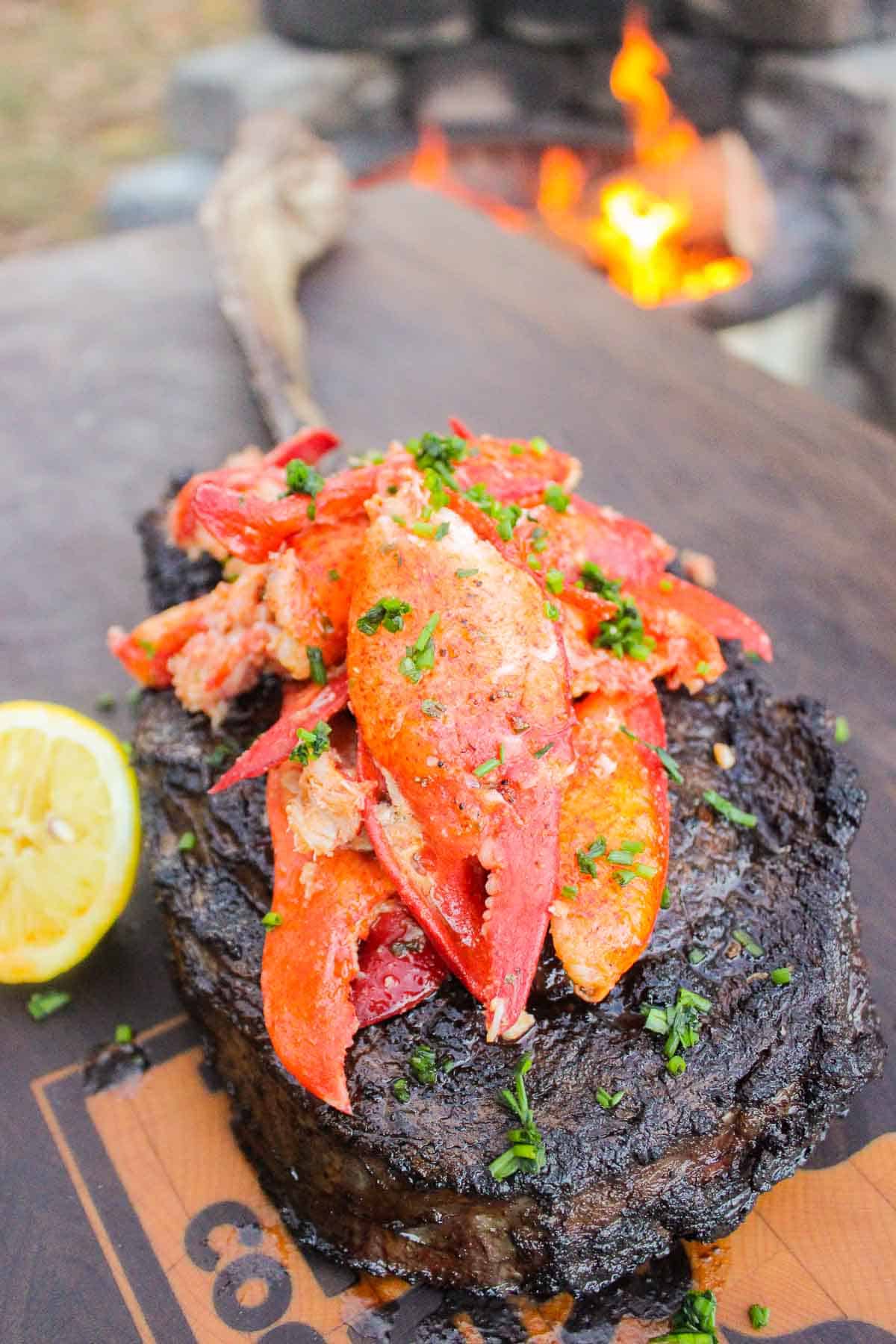 The Garlic Butter Lobster sitting on top of the tomahawk steak.