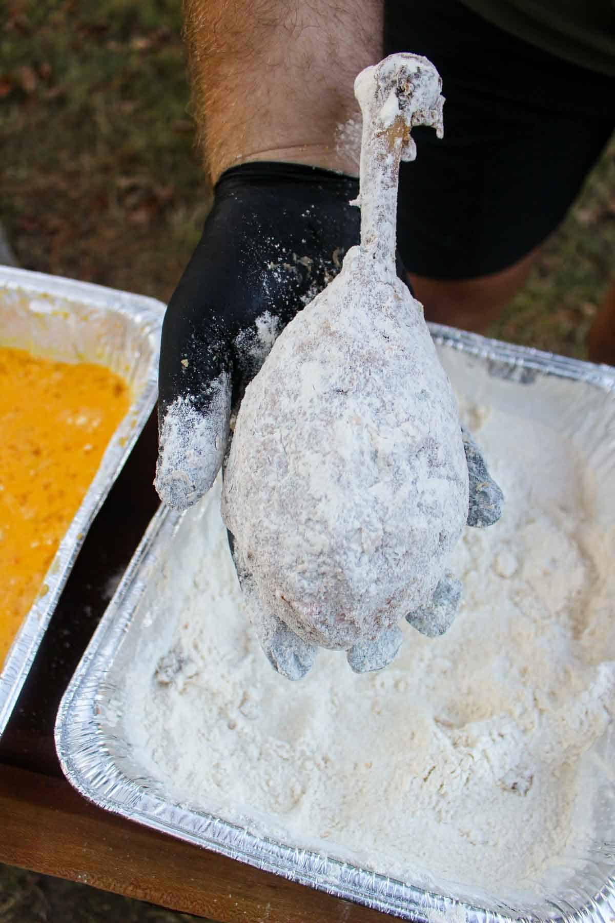The turkey leg covered in a light layer of flour.