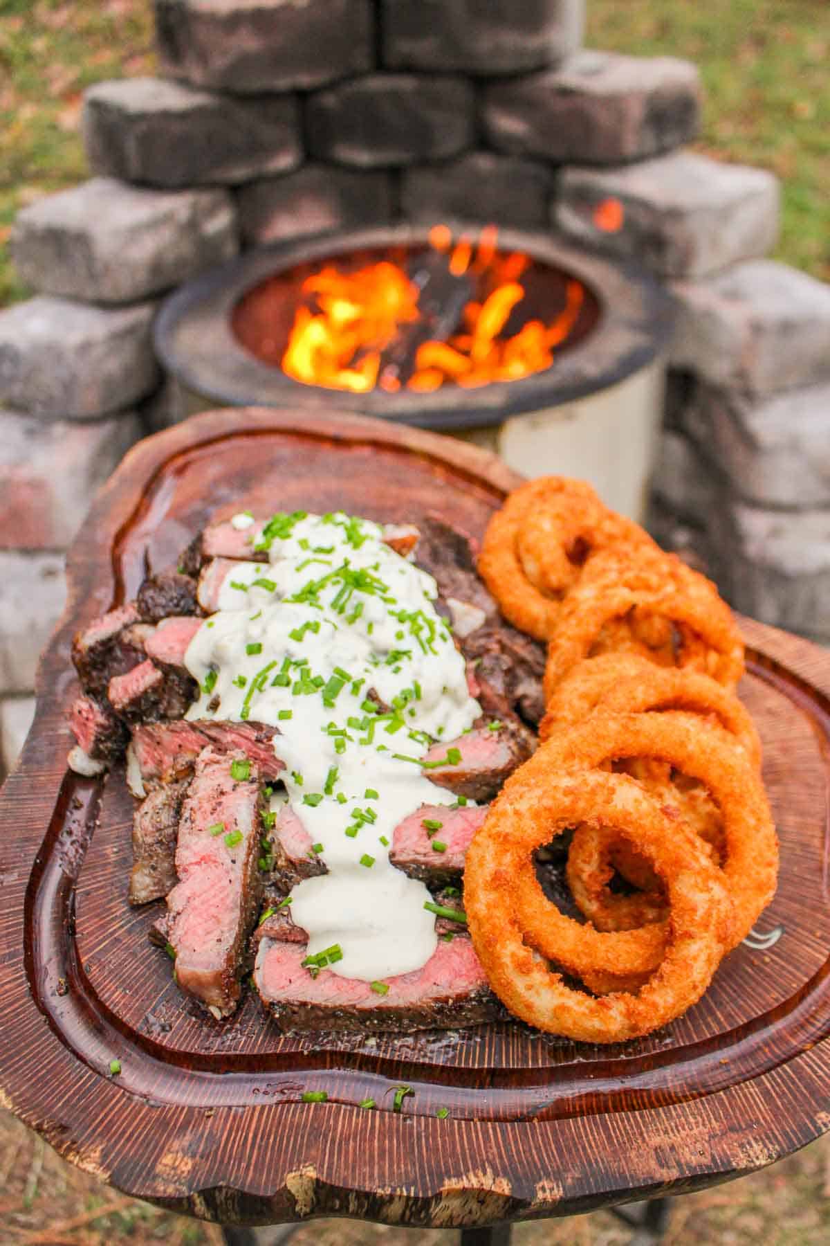 Steak in Beef Tallow sliced and topped with the Hatch Chile Blue Cheese Sauce.