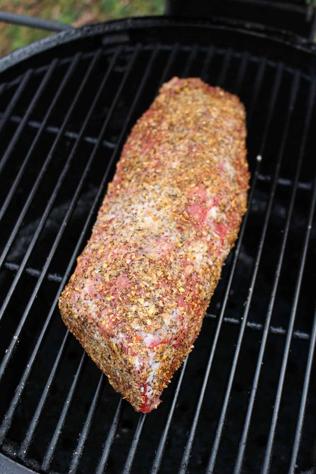 The raw beef getting set on the smoker.