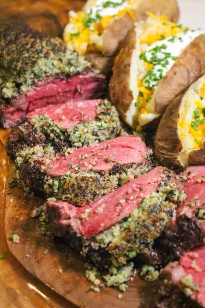 Parmesan Herb Encrusted Beef Tenderloin sliced and ready to serve.