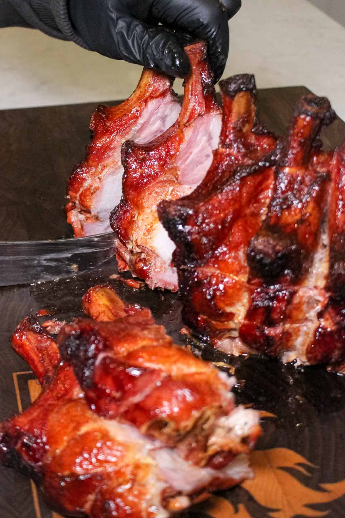Slicing into the Smoked Pork Crown Roast and getting ready to serve. 