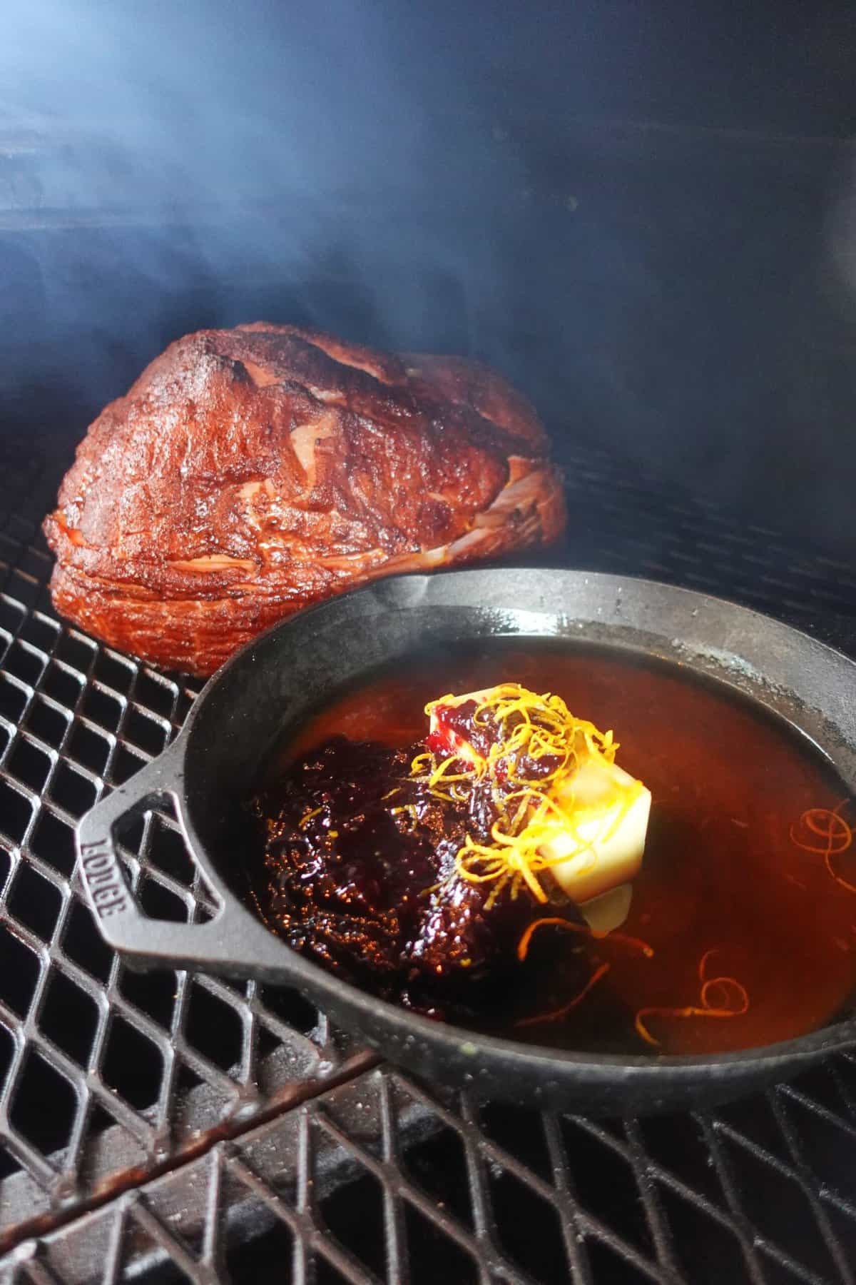 The ham and glaze cooking on the smoker.