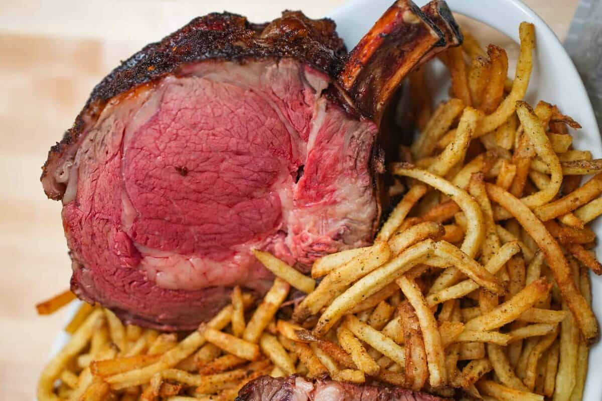 A shot of the cooked prime rib with the fries.