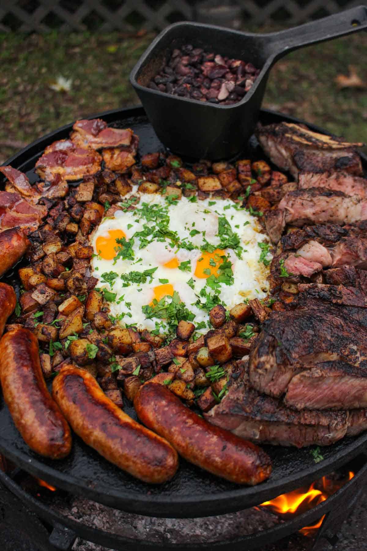 A platter of bacon, chorizo, steak, potatoes, eggs and beans!
