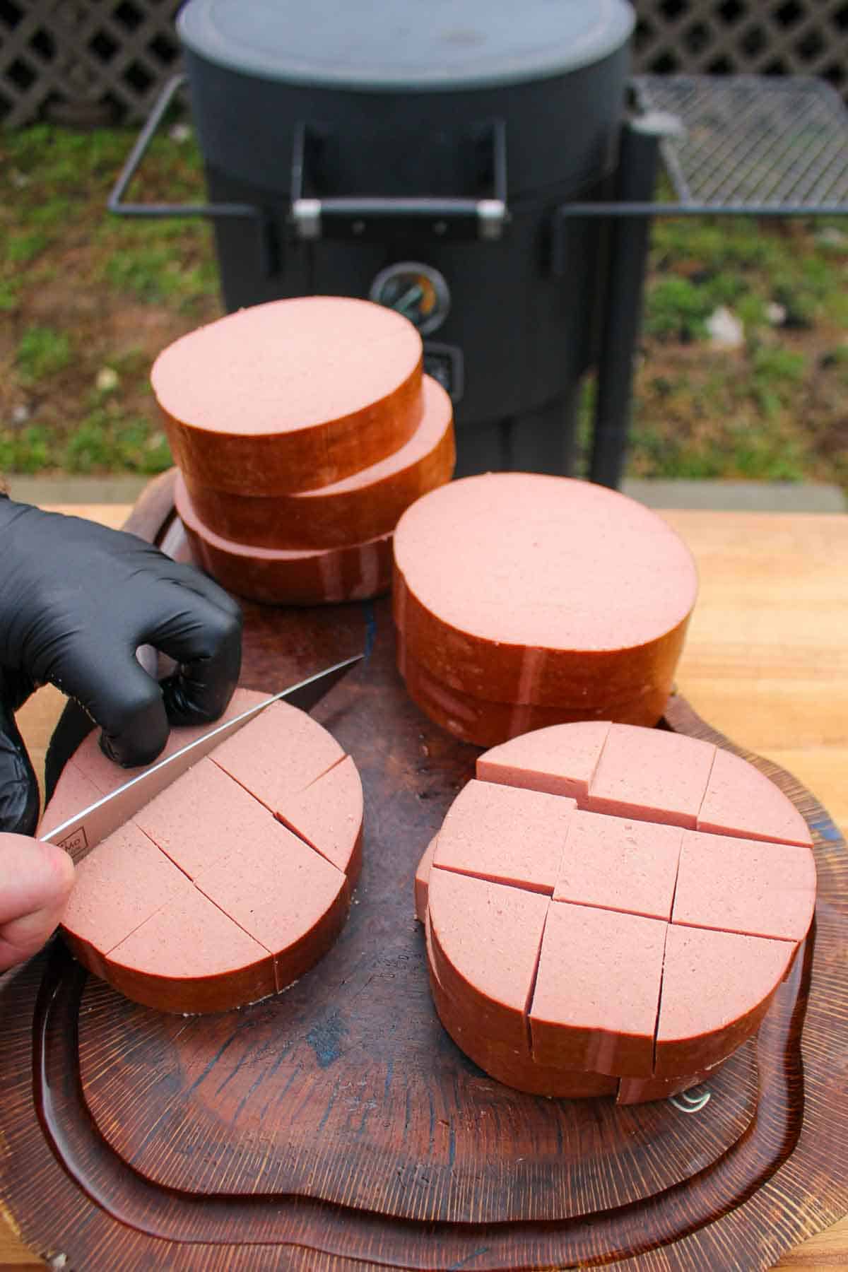 Slicing and prepping the unseasoned bologna.