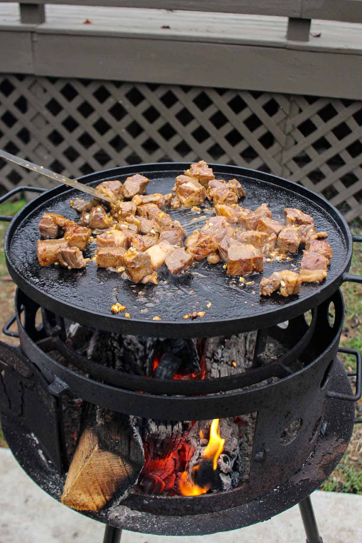 Getting this recipe started by grilling the steak.