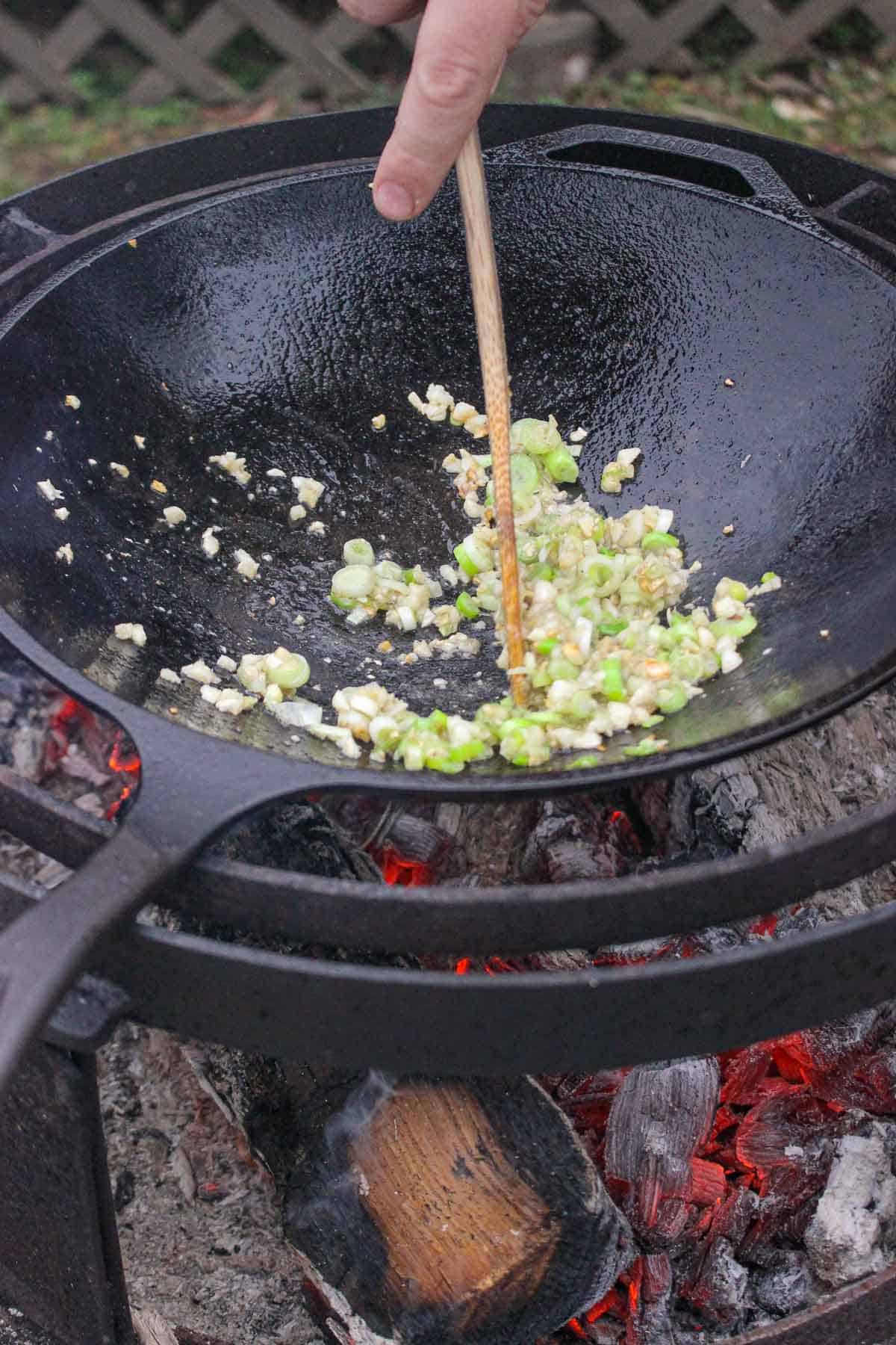 Cooking the garlic, scallions and ginger for the fried rice.