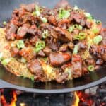 Garlic Teriyaki Steak Bites over a bed of fried rice ready to serve.