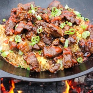 Garlic Teriyaki Steak Bites over a bed of fried rice ready to serve.