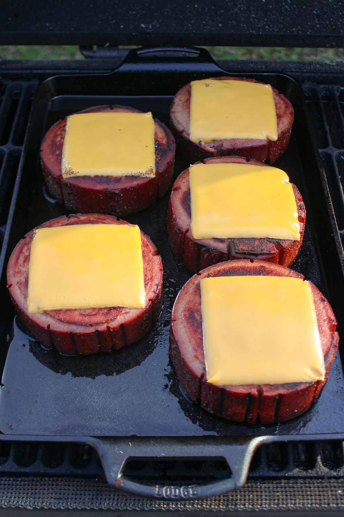 Melted cheese on top of the bologna slices.