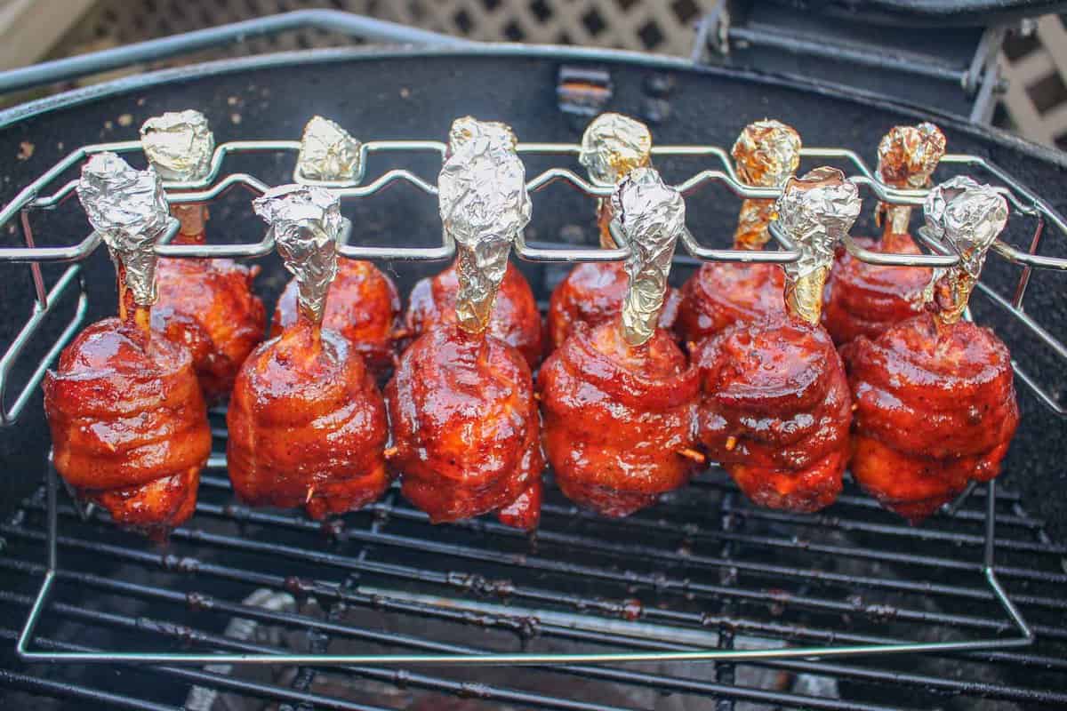 The Honey Bacon BBQ Chicken Lollipops after being glazed, set on the grill for caramelization.