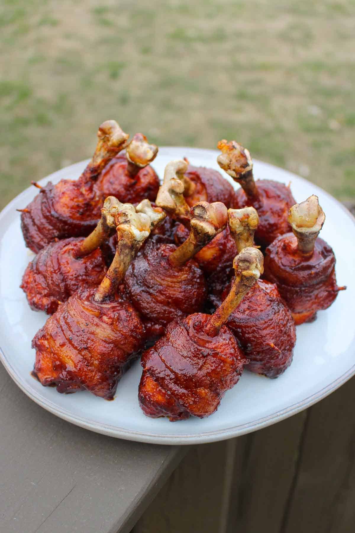 Honey Bacon BBQ Chicken Lollipops all together on a serving platter.