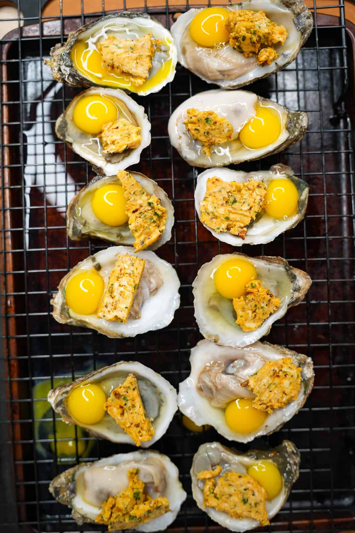 The oysters topped with compound butter and quail eggs.
