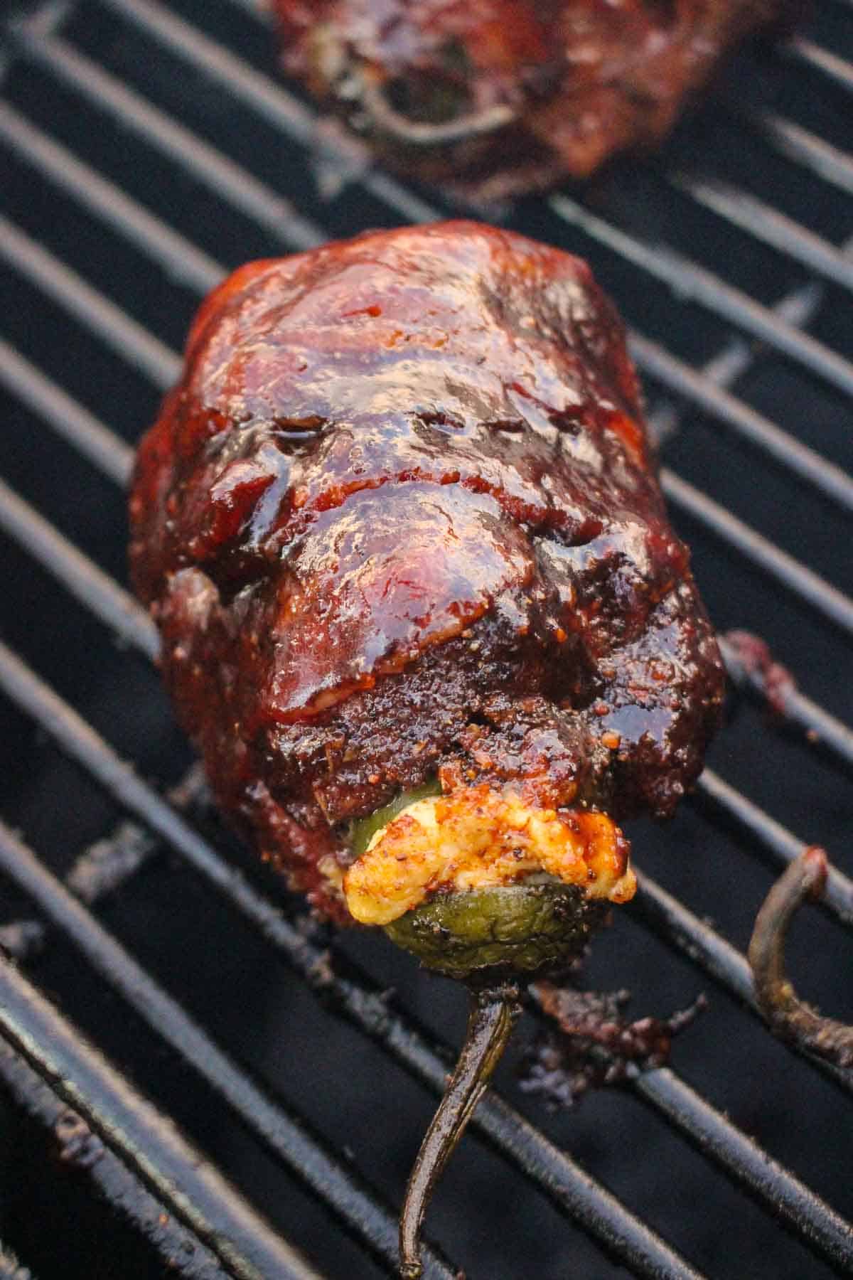 A close up shot of a beef armadillo egg on the smoker.