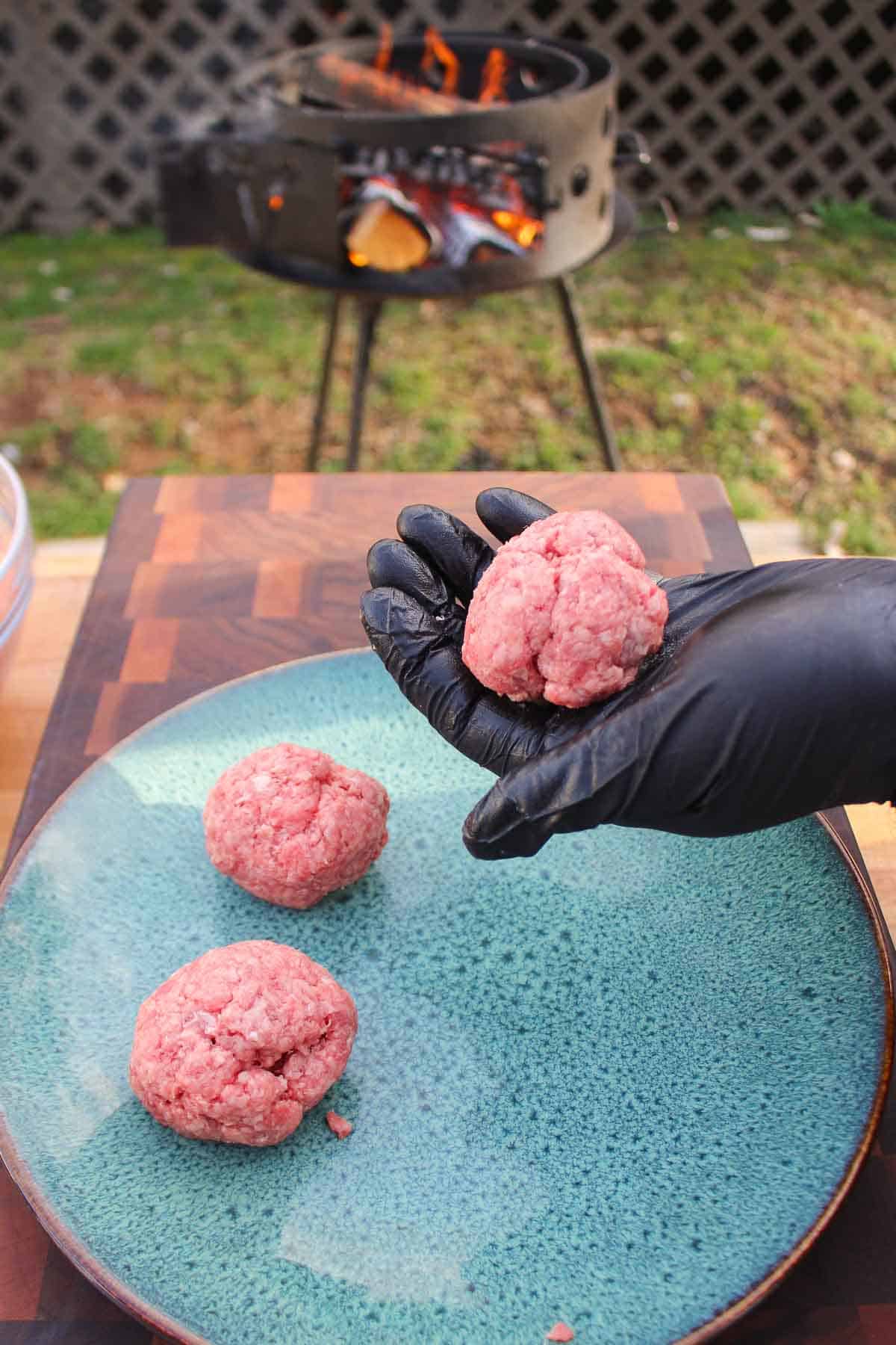 The burger balls formed and ready to be set on the grill.