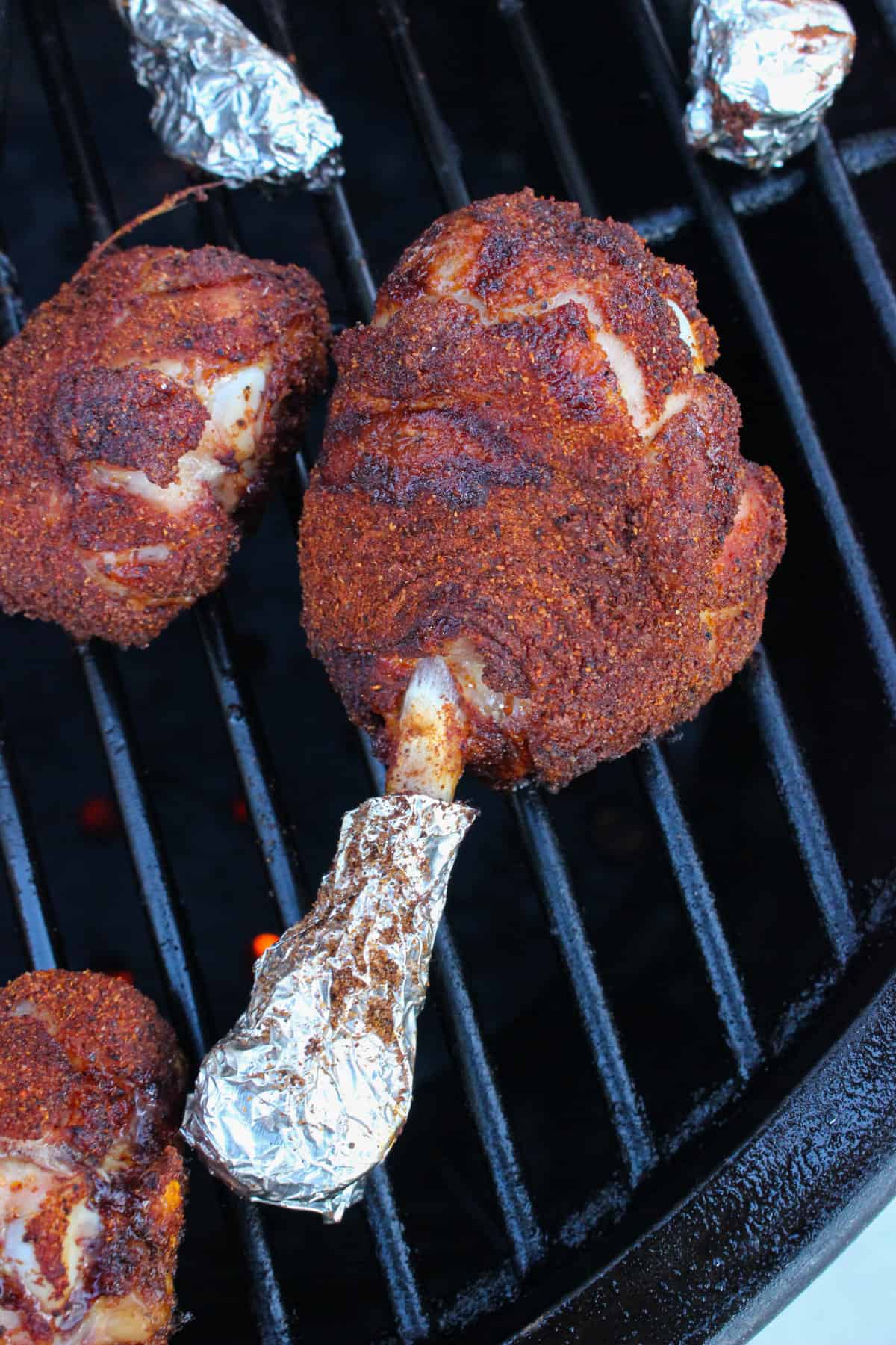 A close up shot of one of the lollipops cooking on the smoker.