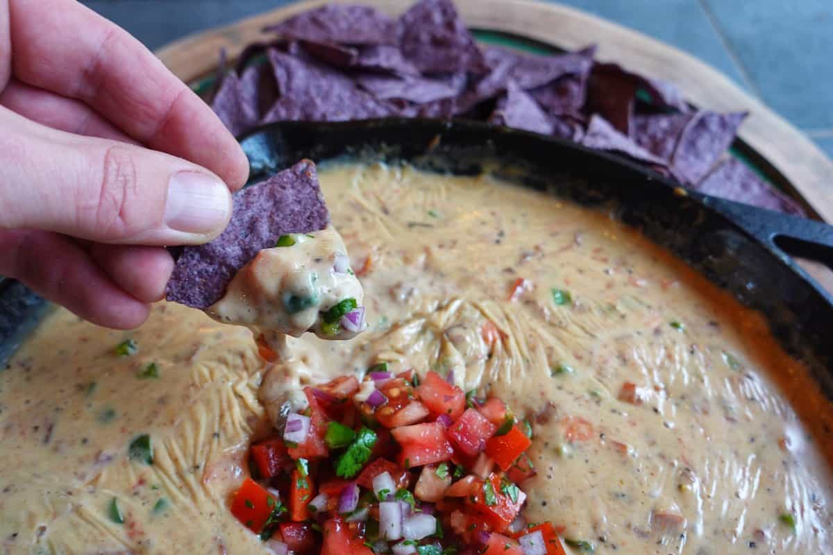 A chip that's been dipped in the smoked brisket queso.